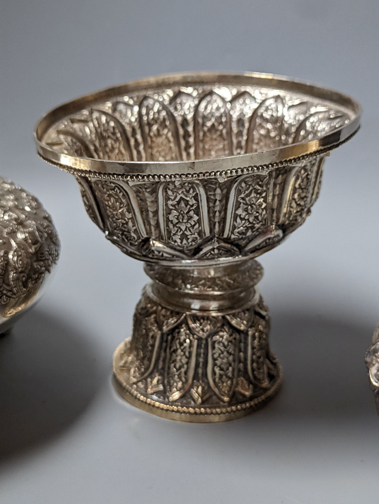 Six assorted embossed white metal bowls, including Indian and Thai, tallest 13.6cm.